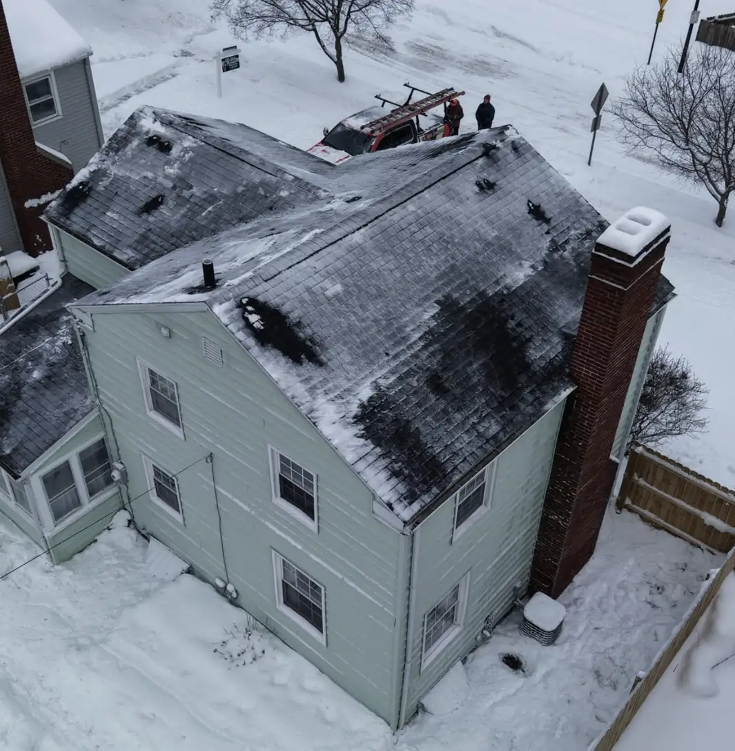 Expert roof repair crew fixing ice dams by trusted Bismarck Roofing Company
