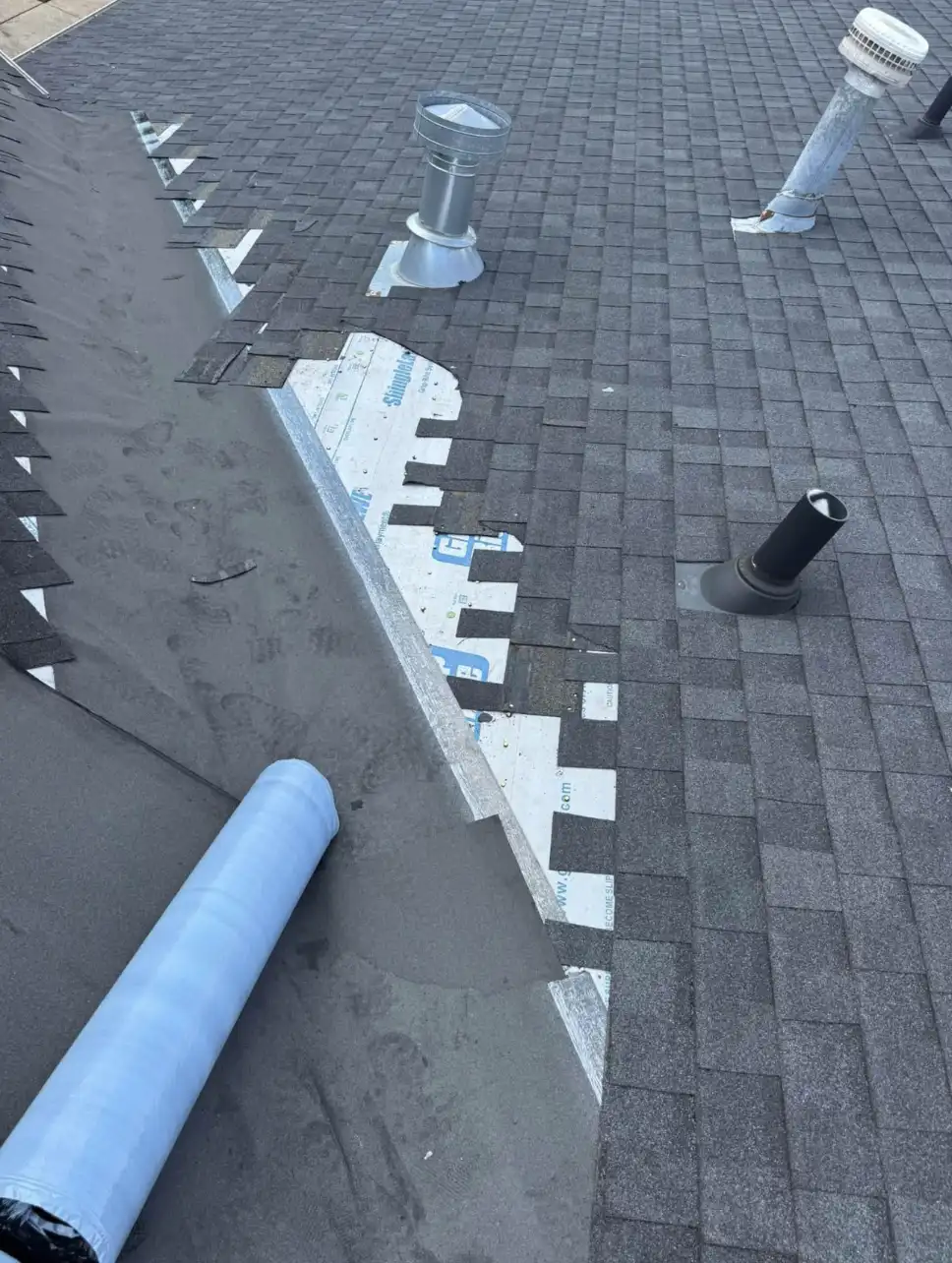 Bismarck, North Dakota commercial roofing contractors installing new asphalt shingles and underlayment on a commercial building roof by Bismarck Exterior Pros.