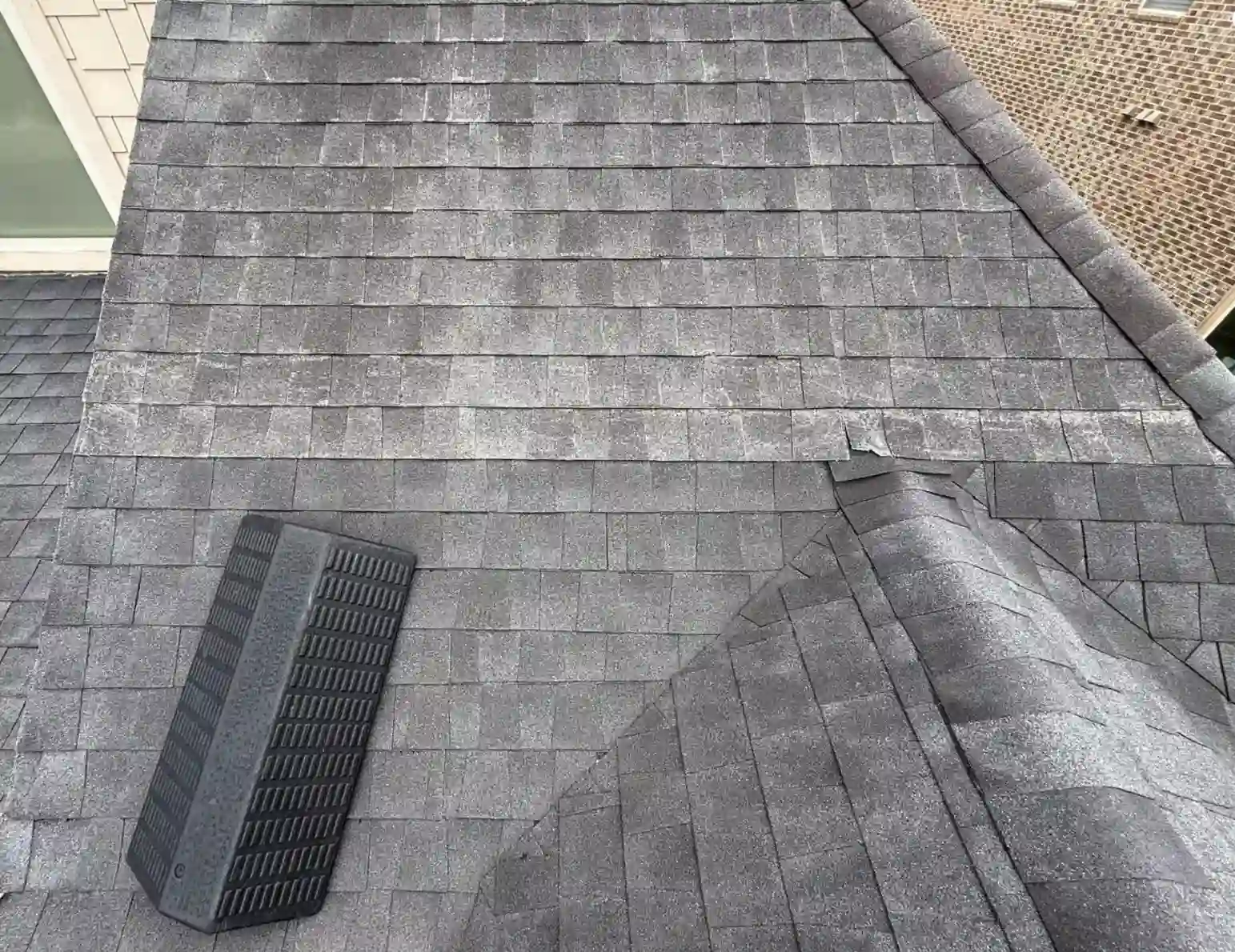 Close-up of asphalt shingle roof showing granule loss and wear during a Bismarck, North Dakota roof inspection by Bismarck Exterior Pros.