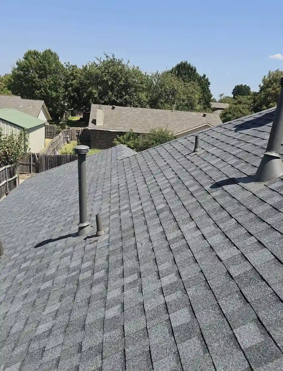 Completed roof replacement in Bismarck, North Dakota, featuring new grey asphalt shingles and vent pipe flashing installed by Bismarck Exterior Pros.