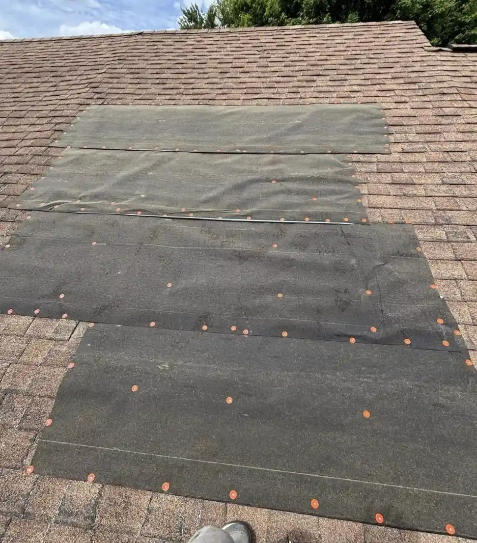 Emergency roof tarping after wind damage by leading Bismarck Roofing Company